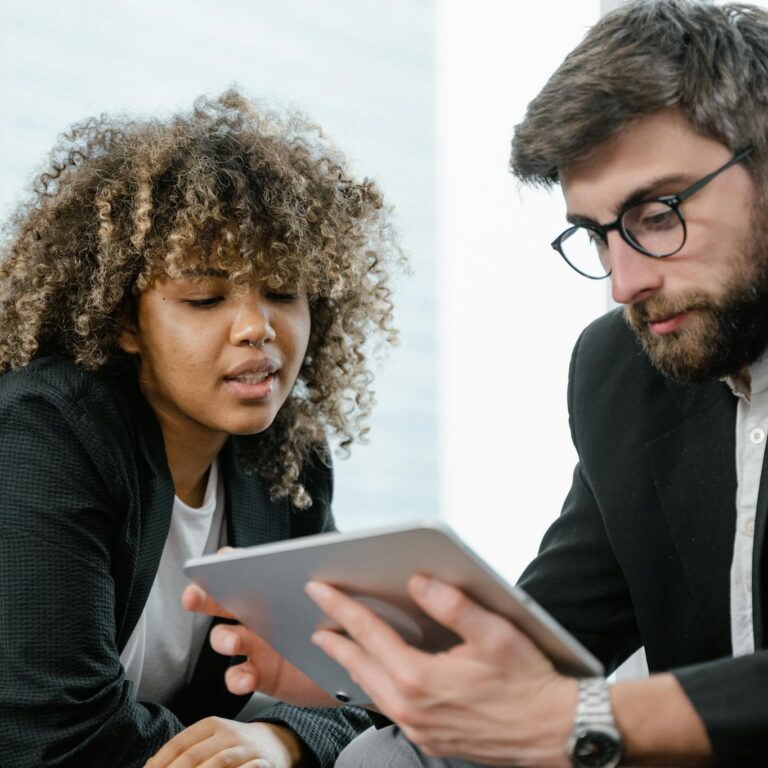 Man in Black Suit Jacket Holding Black Tablet Computer