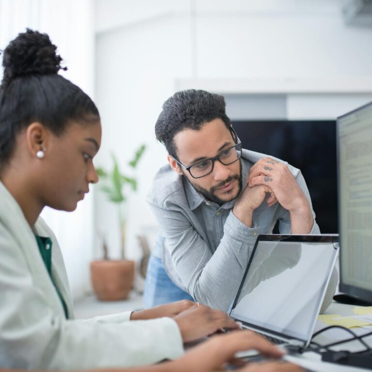 Man in Gray Shirt Looking at the Monitor